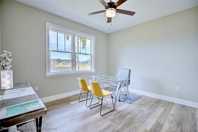 dining room with light wood-type flooring and ceiling fan