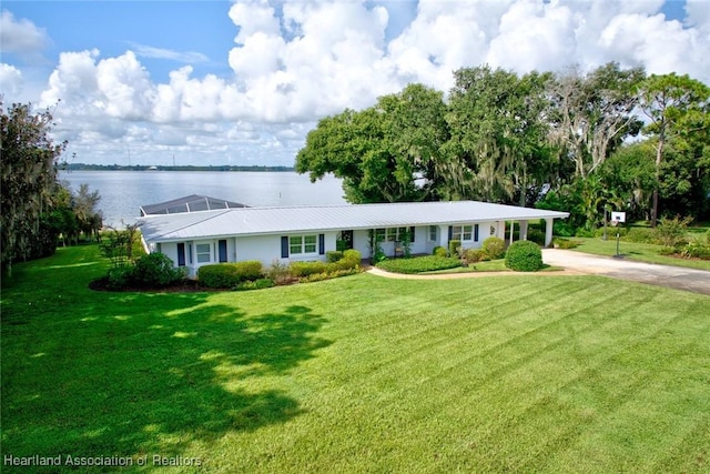 single story home featuring a front yard and a water view