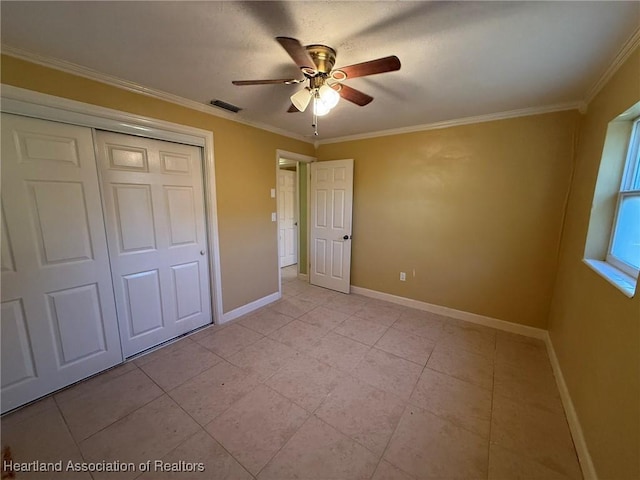 unfurnished bedroom featuring ceiling fan, light tile patterned flooring, ornamental molding, and a closet