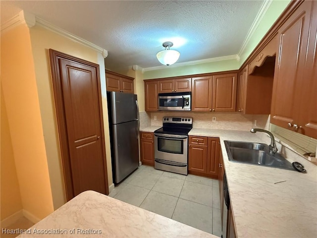 kitchen featuring sink, light tile patterned floors, stainless steel appliances, and ornamental molding