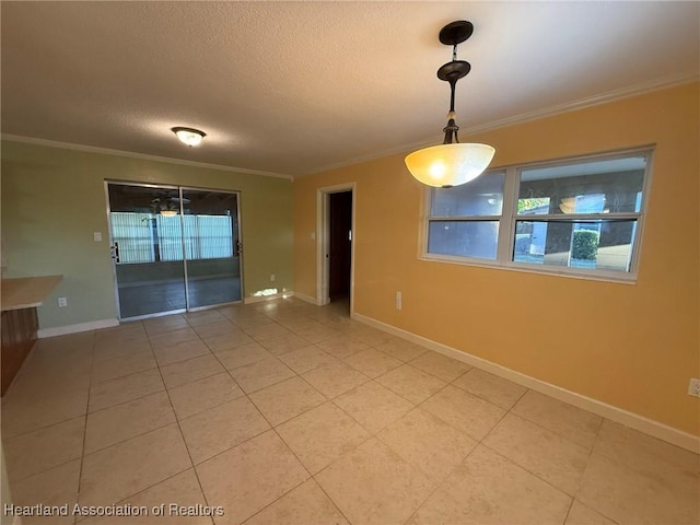 unfurnished dining area featuring a textured ceiling and ornamental molding