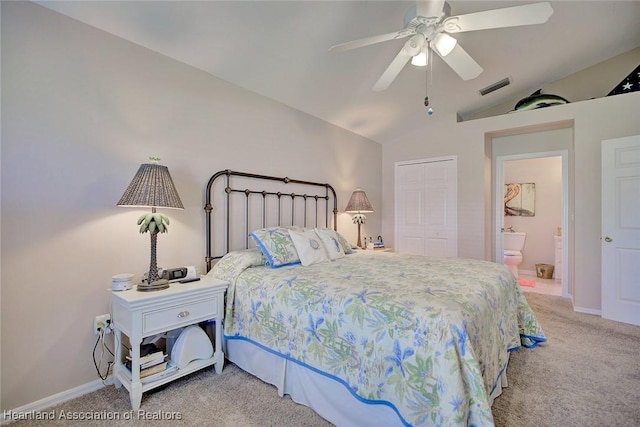 bedroom featuring connected bathroom, ceiling fan, carpet floors, vaulted ceiling, and a closet