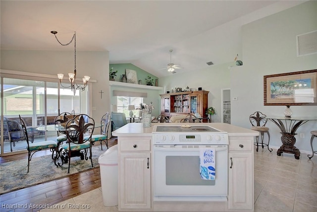 kitchen featuring a center island with sink, ceiling fan with notable chandelier, white cabinetry, and white electric stove