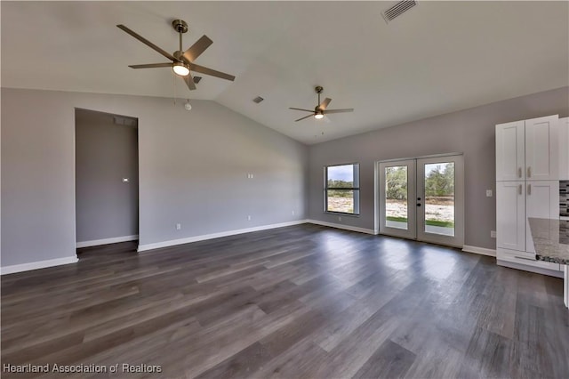 unfurnished living room with vaulted ceiling, dark hardwood / wood-style floors, ceiling fan, and french doors