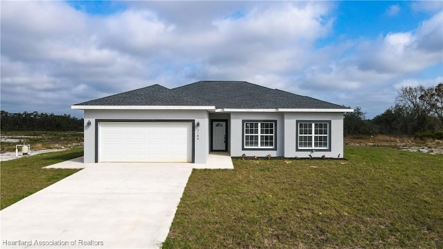 view of front of property featuring a garage and a front lawn