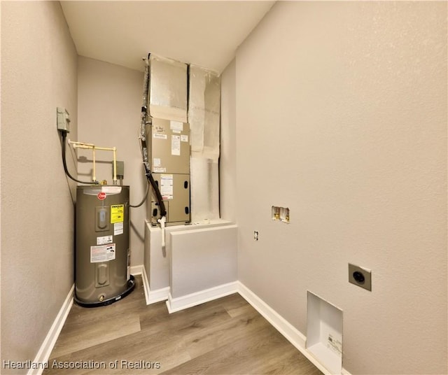 utility room with electric water heater and heating unit