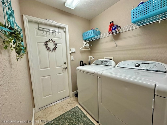 241 Sheppard Rd NW, Lake Placid, FL 33852 - clothes washing area featuring washing machine and clothes dryer, laundry area, a textured ceiling, a textured wall, and light tile patterned flooring