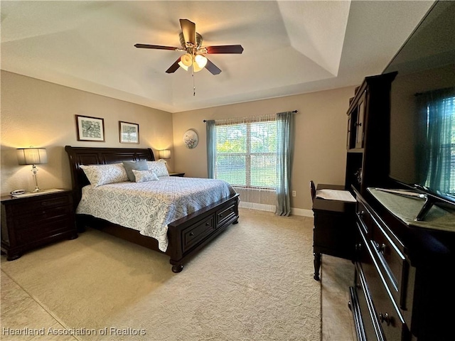 241 Sheppard Rd NW, Lake Placid, FL 33852 - bedroom with a ceiling fan, light carpet, a tray ceiling, and baseboards