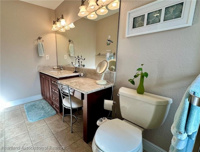 241 Sheppard Rd NW, Lake Placid, FL 33852 - bathroom featuring toilet, tile patterned flooring, vanity, and a notable chandelier