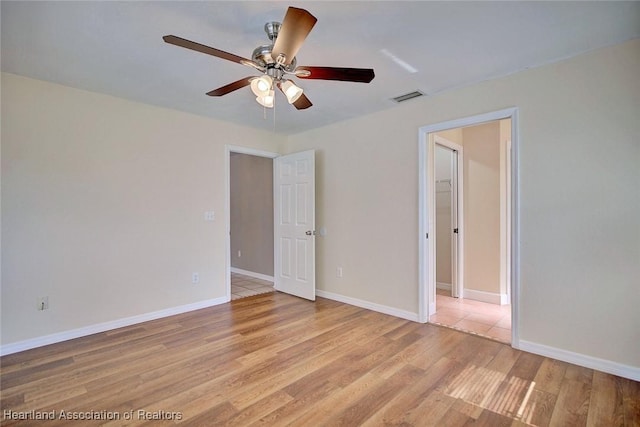 spare room featuring ceiling fan and light wood-type flooring