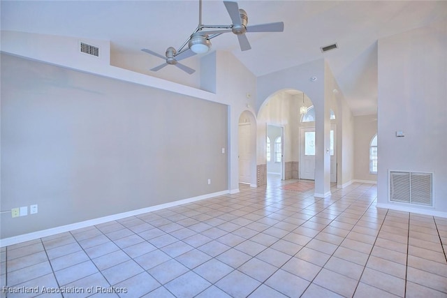 unfurnished room featuring high vaulted ceiling, ceiling fan, and light tile patterned flooring