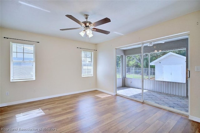 spare room featuring light hardwood / wood-style flooring and ceiling fan