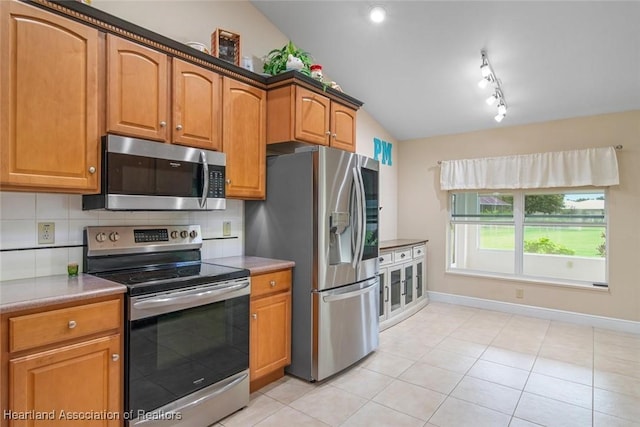 800 Spring Blvd, Sebring, FL 33876 - kitchen featuring appliances with stainless steel finishes, baseboards, backsplash, light countertops, and brown cabinets