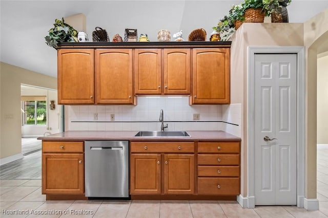 800 Spring Blvd, Sebring, FL 33876 - kitchen featuring dishwasher, a sink, tasteful backsplash, baseboards, and brown cabinetry