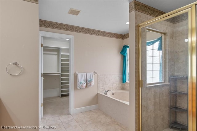 800 Spring Blvd, Sebring, FL 33876 - bathroom with a shower stall, a spacious closet, a bath, and baseboards