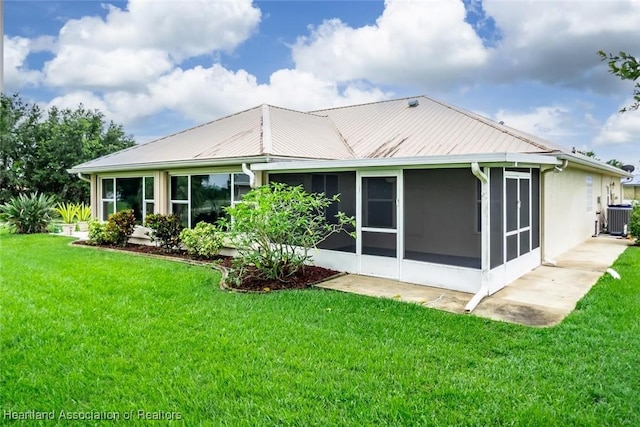 800 Spring Blvd, Sebring, FL 33876 - back of house with central AC unit, a sunroom, a yard, and metal roof