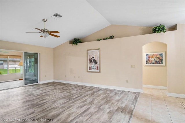 800 Spring Blvd, Sebring, FL 33876 - spare room featuring vaulted ceiling, a ceiling fan, light wood-style flooring, and baseboards