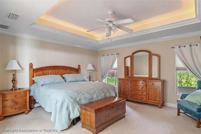 800 Spring Blvd, Sebring, FL 33876 - bedroom featuring a tray ceiling, light carpet, a ceiling fan, and crown molding