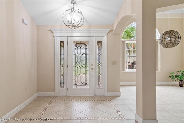 800 Spring Blvd, Sebring, FL 33876 - entryway featuring a chandelier, baseboards, arched walkways, and tile patterned flooring
