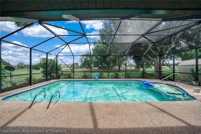 view of swimming pool with a lanai and a patio area