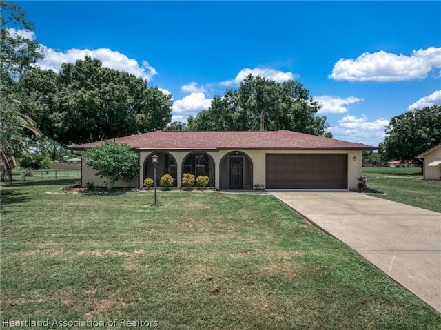 view of front of house with a front yard and a garage