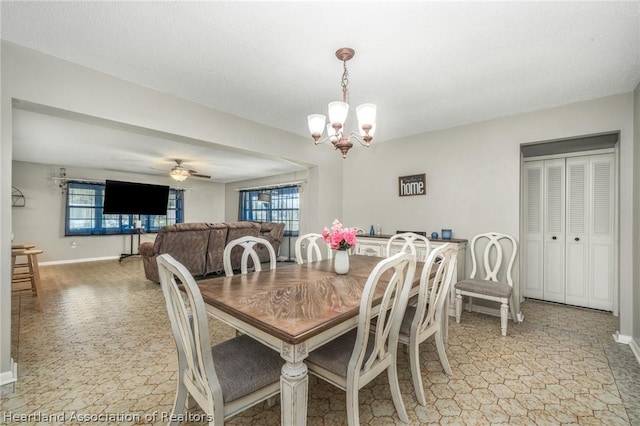 dining room featuring ceiling fan with notable chandelier