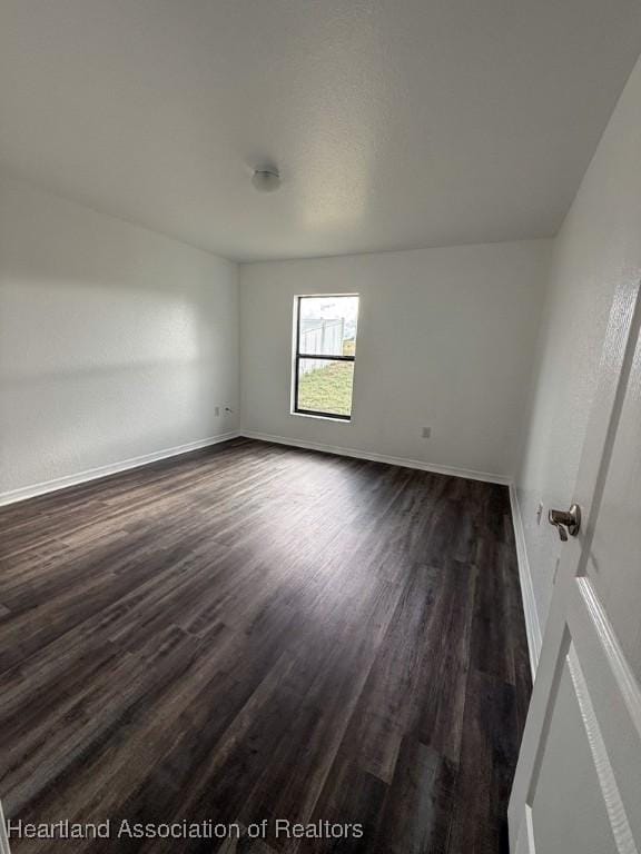 525 Central Ln, Frostproof, FL 33843 - unfurnished room with dark wood-type flooring and baseboards
