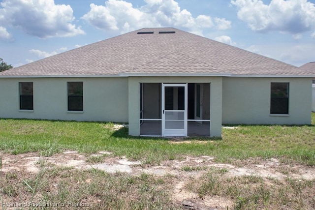 525 Central Ln, Frostproof, FL 33843 - rear view of property with roof with shingles, stucco siding, a sunroom, and a yard