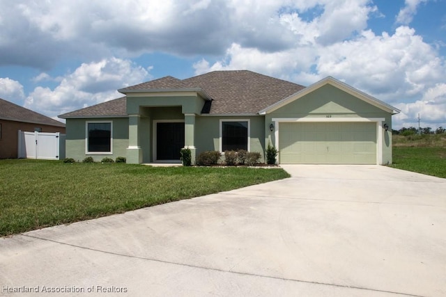 525 Central Ln, Frostproof, FL 33843 - view of front of property with roof with shingles, stucco siding, driveway, an attached garage, and a gate