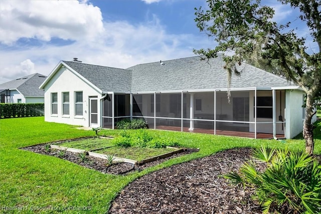 rear view of property featuring a lawn