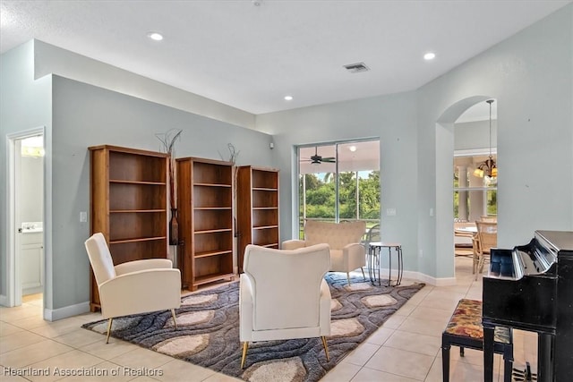 living area featuring light tile patterned floors and an inviting chandelier