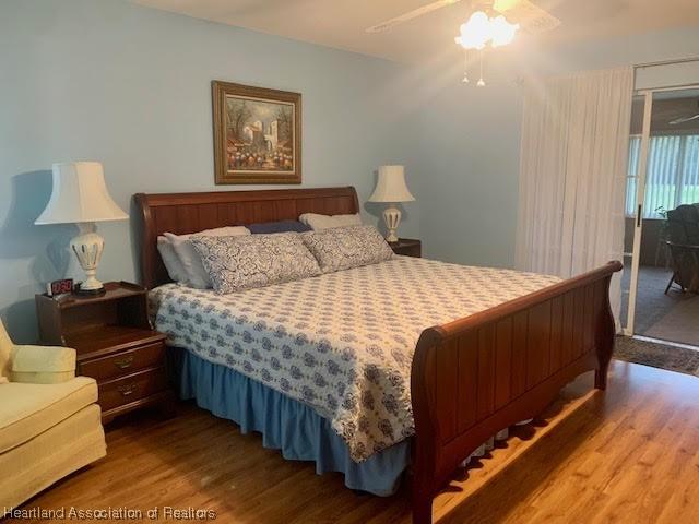 bedroom with hardwood / wood-style floors and ceiling fan