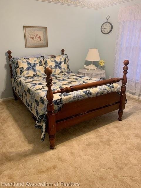 bedroom featuring light colored carpet