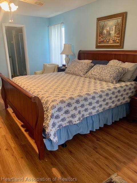 bedroom with hardwood / wood-style floors