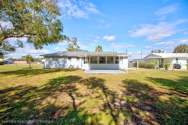 back of property featuring a lawn and a patio
