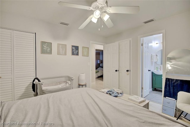 bedroom with ensuite bathroom, ceiling fan, and light tile patterned flooring