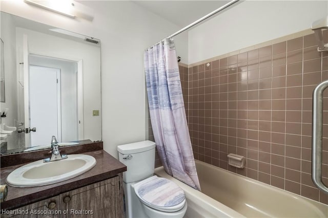 full bathroom with shower / tub combo, vanity, and toilet