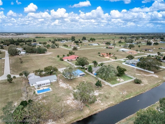 drone / aerial view featuring a water view and a rural view