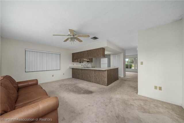 living room featuring light carpet and ceiling fan