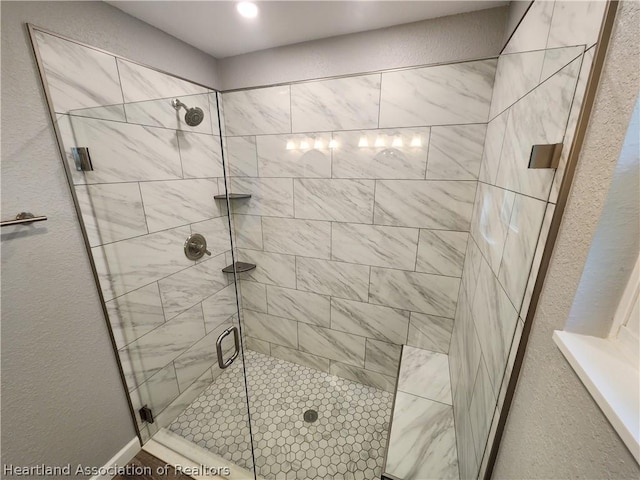 bathroom featuring a shower with shower door