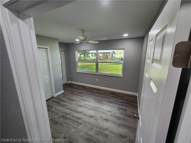 unfurnished room featuring dark hardwood / wood-style floors and ceiling fan