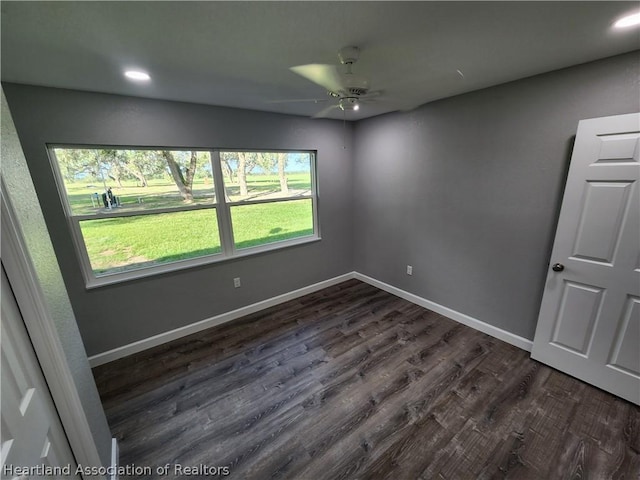 empty room featuring ceiling fan and dark hardwood / wood-style floors