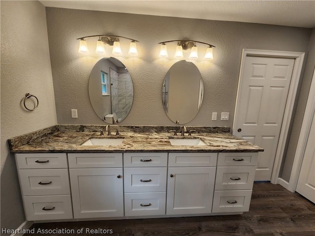 bathroom with vanity and hardwood / wood-style flooring