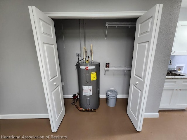 utility room featuring sink and water heater