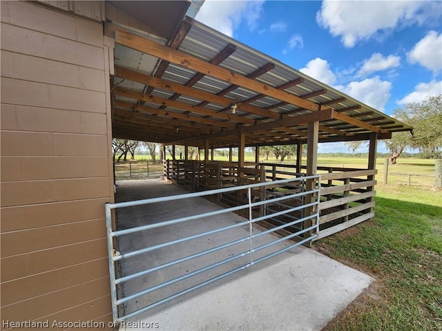 view of horse barn featuring a rural view