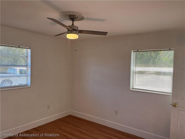 spare room featuring hardwood / wood-style floors and ceiling fan