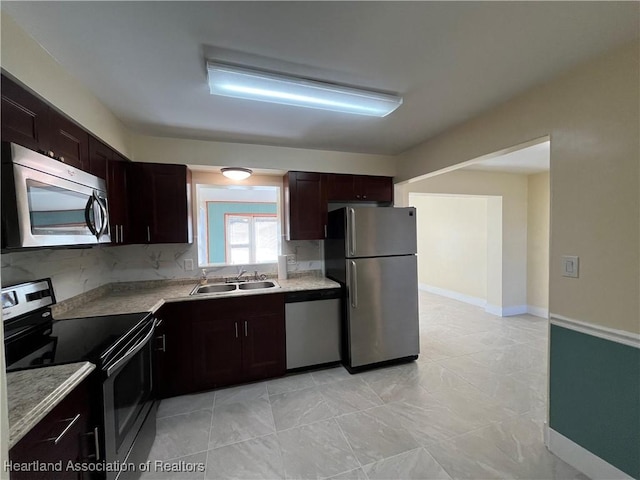 kitchen featuring dark brown cabinets, stainless steel appliances, and sink