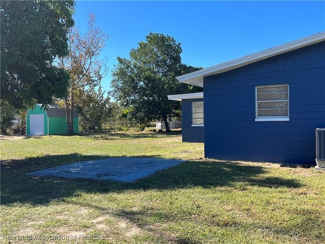 view of yard featuring a shed and a patio