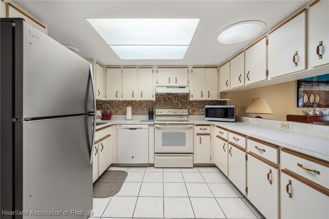 158 Parkview Cir, Lake Placid, FL 33852 - kitchen featuring appliances with stainless steel finishes, under cabinet range hood, light countertops, and light tile patterned flooring