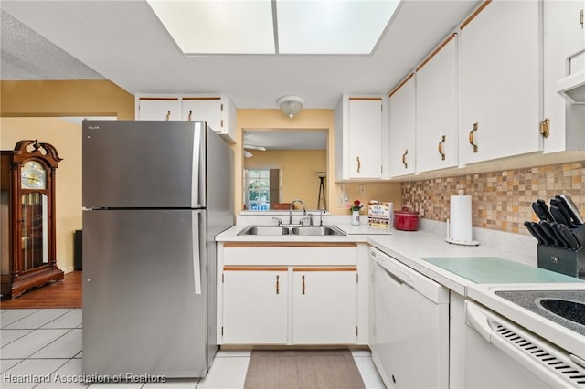 158 Parkview Cir, Lake Placid, FL 33852 - kitchen featuring freestanding refrigerator, a sink, dishwasher, light tile patterned flooring, and light countertops